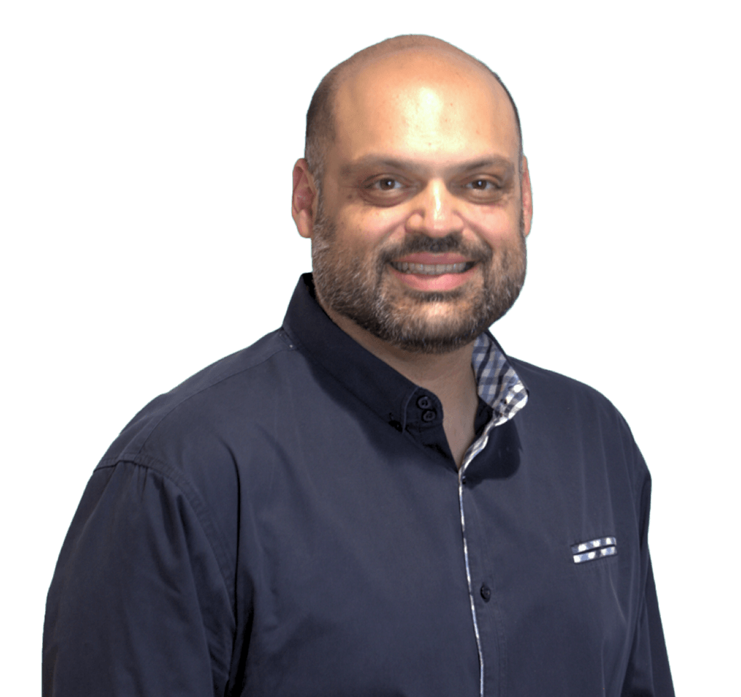 Smiling man with a beard wearing a dark button-up shirt, standing against a plain white background.